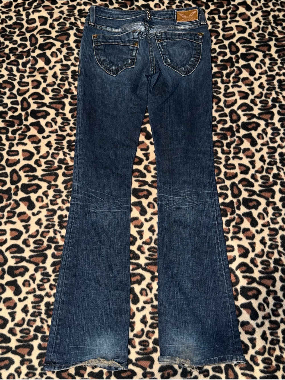 2000s style low rise bootcut jeans with tattoo-style wings